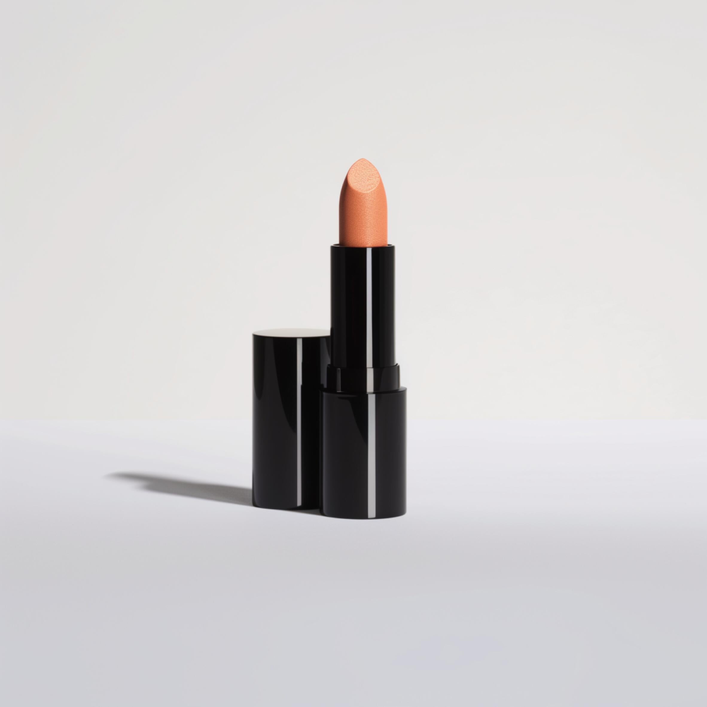 Rouge à lèvres nude dans un étui noir sur fond blanc, maquillage beauté élégant